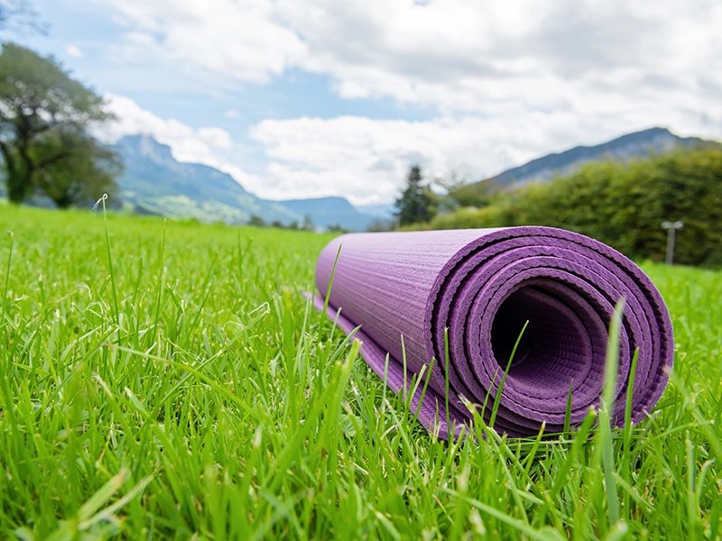 Colchoneta de yoga en un campo en la montaña. Retiro de Yoga.